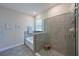 Modern bathroom with a walk-in shower, soaking tub, and gray tile at 17723 Gulf Ranch Pl, Lakewood Ranch, FL 34211