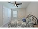 Charming bedroom with a metal bed frame and window with blinds at 17723 Gulf Ranch Pl, Lakewood Ranch, FL 34211