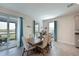 Dining area with a wooden table, four chairs, and teal curtains at 17723 Gulf Ranch Pl, Lakewood Ranch, FL 34211