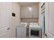 Convenient laundry room with washer, dryer, and overhead storage at 17723 Gulf Ranch Pl, Lakewood Ranch, FL 34211