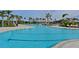 Large community pool with lounge chairs and palm trees at 17723 Gulf Ranch Pl, Lakewood Ranch, FL 34211