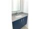 Small bathroom with a navy blue vanity and a modern sink at 2110 Michele Dr, Sarasota, FL 34231