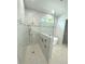 Spa-like bathroom with walk-in shower, soaking tub, and marble tile at 2110 Michele Dr, Sarasota, FL 34231