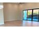 Bright living room with hardwood floors and sliding glass doors to the pool at 2110 Michele Dr, Sarasota, FL 34231