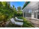 Relaxing backyard with lounge chairs and grassy area next to patio at 2254 Hawthorne St, Sarasota, FL 34239