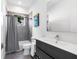 Modern bathroom with gray tile, bathtub, and floating vanity at 2254 Hawthorne St, Sarasota, FL 34239