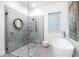 Modern bathroom with freestanding tub, walk-in shower, and updated fixtures at 2254 Hawthorne St, Sarasota, FL 34239