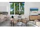 Bright dining area with white table and chairs, overlooking a lush garden at 2254 Hawthorne St, Sarasota, FL 34239