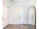 Bright entryway with white walls, wood-look floors, and an arched mirror at 2254 Hawthorne St, Sarasota, FL 34239