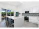 Modern kitchen with island, stainless steel appliances, and view to backyard at 2254 Hawthorne St, Sarasota, FL 34239