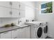 Laundry room with white cabinets, washer, and dryer at 2254 Hawthorne St, Sarasota, FL 34239