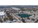 Wide aerial view shows the property's location near a scenic lake and surrounding neighborhood at 2321 Terry Ln, Sarasota, FL 34231