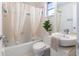 Cozy bathroom featuring a tub with shower, small window and ample sink space at 2321 Terry Ln, Sarasota, FL 34231