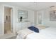 Well-lit bedroom featuring a neatly made bed, a dresser, and a view into the ensuite bathroom and closet at 2321 Terry Ln, Sarasota, FL 34231