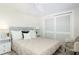 Bright bedroom featuring a large bed, white nightstands, and built-in closet at 2321 Terry Ln, Sarasota, FL 34231