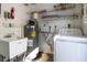 Practical laundry room with sink, shelving, washer, and dryer hookups at 2321 Terry Ln, Sarasota, FL 34231