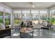 Light-filled sunroom featuring stylish seating, a round table, and large windows that provide picturesque outdoor views at 2321 Terry Ln, Sarasota, FL 34231