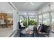 Bright sunroom with wicker furniture, surrounded by windows offering serene views of the lush greenery at 2321 Terry Ln, Sarasota, FL 34231