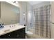 Clean bathroom with shower/tub combo, vanity, and updated fixtures at 2582 Wild Cherry Path, Sarasota, FL 34240