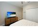 Bedroom with queen bed, large closet, and flat-screen TV at 2582 Wild Cherry Path, Sarasota, FL 34240