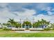 Community clubhouse with palm trees and landscaping at 2582 Wild Cherry Path, Sarasota, FL 34240