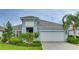 Two-story house with light blue exterior and white garage at 2582 Wild Cherry Path, Sarasota, FL 34240