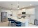 Well-equipped kitchen with white cabinetry and large island at 2582 Wild Cherry Path, Sarasota, FL 34240