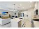 Modern kitchen with white cabinets, island, and stainless steel appliances at 2582 Wild Cherry Path, Sarasota, FL 34240