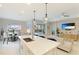 Open concept kitchen with island and living room view at 2582 Wild Cherry Path, Sarasota, FL 34240