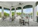 Relaxing outdoor patio area with tables and chairs overlooking the pool at 2582 Wild Cherry Path, Sarasota, FL 34240