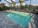 Refreshing screened pool with gray pavers at 2582 Wild Cherry Path, Sarasota, FL 34240