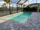 Inviting screened pool with gray pavers at 2582 Wild Cherry Path, Sarasota, FL 34240