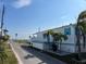 View of street with white single-wide home with teal accents at 2601 Gulf N Dr # 427, Bradenton Beach, FL 34217