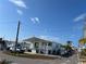 White single-wide home with teal accents and covered porch at 2601 Gulf N Dr # 427, Bradenton Beach, FL 34217