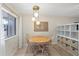 Cozy dining area with a round table, three chairs, and natural light from a nearby window at 3101 Bee Ridge Rd # 118, Sarasota, FL 34239