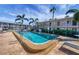 Community pool with lounge chairs and palm trees at 3101 Bee Ridge Rd # 118, Sarasota, FL 34239