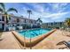 Community pool with lounge chairs and palm trees at 3101 Bee Ridge Rd # 118, Sarasota, FL 34239