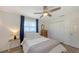 Bright bedroom featuring a ceiling fan, natural light, and spacious closet at 3302 21St Avenue W Dr, Bradenton, FL 34205