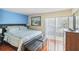 Spacious bedroom with king-size bed and access to balcony at 3368 Ramblewood Pl # 37D1, Sarasota, FL 34237