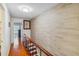 Bright hallway with wood flooring and a brick accent wall at 3368 Ramblewood Pl # 37D1, Sarasota, FL 34237