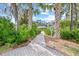 Paver path leading to the Villas of Cedar Creek, surrounded by lush greenery at 3622 Bonaventure Ct, Sarasota, FL 34243