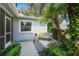 Charming outdoor seating area with lush tropical landscaping creating a private oasis at 3622 Bonaventure Ct, Sarasota, FL 34243