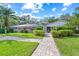 Beautiful, well-maintained exterior of the home with lush landscaping and a paver walkway at 3622 Bonaventure Ct, Sarasota, FL 34243