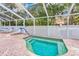 A screened-in outdoor hot tub area featuring brick pavers at 3622 Bonaventure Ct, Sarasota, FL 34243