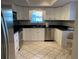 Bright kitchen with white cabinetry, stainless steel appliances, and a breakfast bar at 3622 Bonaventure Ct, Sarasota, FL 34243