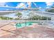 Outdoor screened pool area with brick pavers surrounding the pool and hot tub at 3622 Bonaventure Ct, Sarasota, FL 34243