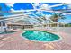 Screened pool area featuring brick pavers, clear blue water, and a hot tub at 3622 Bonaventure Ct, Sarasota, FL 34243