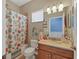 Clean bathroom with tub shower, vanity, and decorative accents at 4007 Overture Cir, Bradenton, FL 34209