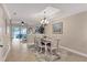 Bright dining room featuring a farmhouse table and access to the living room at 4007 Overture Cir, Bradenton, FL 34209