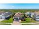 Single-story home with tile roof, two-car garage, and a green lawn at 413 Wildlife Gln, Bradenton, FL 34209